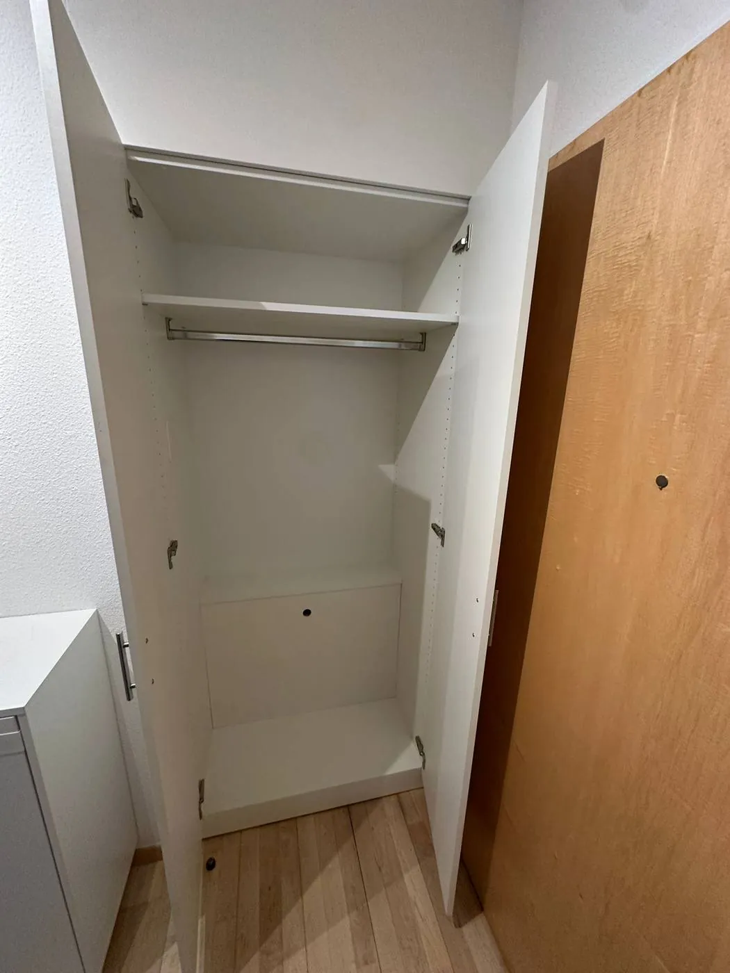 Interior of bespoke wardrobe with rail and shelving