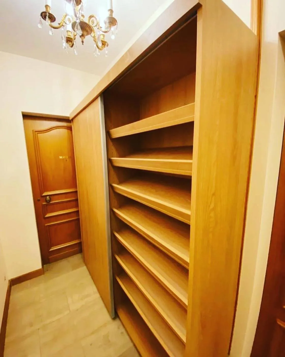 Bespoke wardrobe with sliding rail and wood shelving