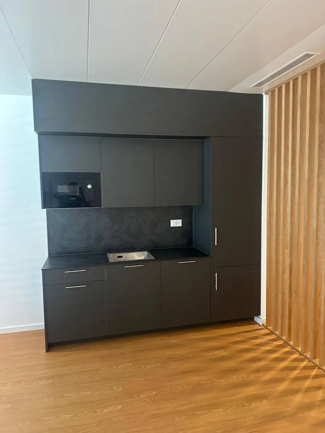 Bespoke kitchenette in anthracite finish with built-in microwave